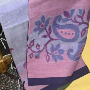 Authentic Tangail Tant cotton saree by Abhrikaa in deep purple, featuring traditional hand-woven pink floral and white Kolka (paisley) motifs across the body and border.