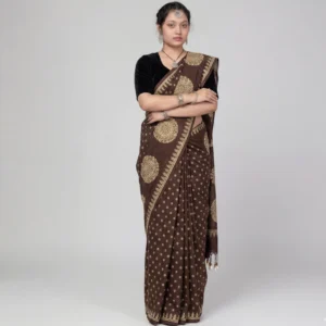 Woman wearing brown block print cotton saree with gold mandala pallu, front view